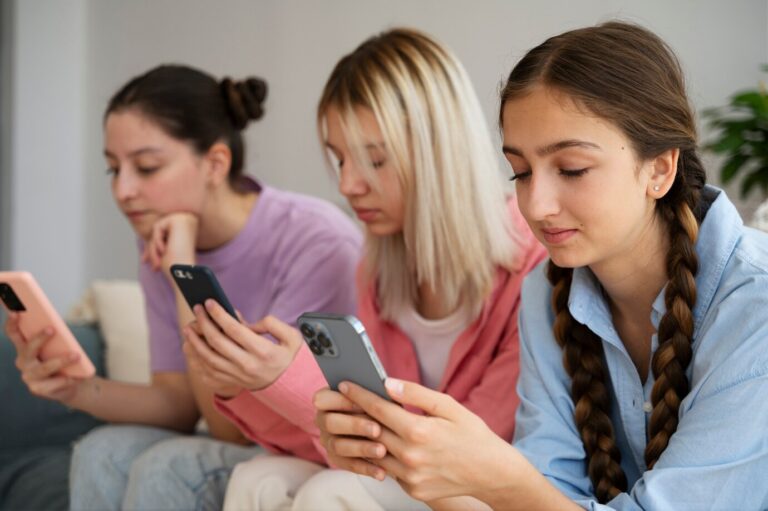 vue laterale filles tenant smartphones 23 2149458384